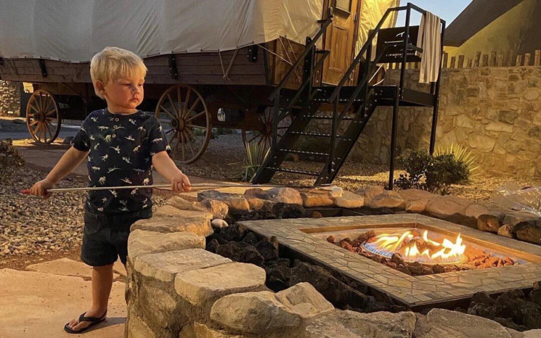 Child roasting marshmallow over open fire