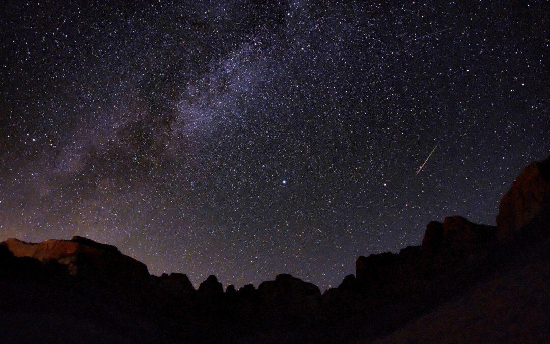 Starry night sky in Zion National Park with shooting star and milky way visible