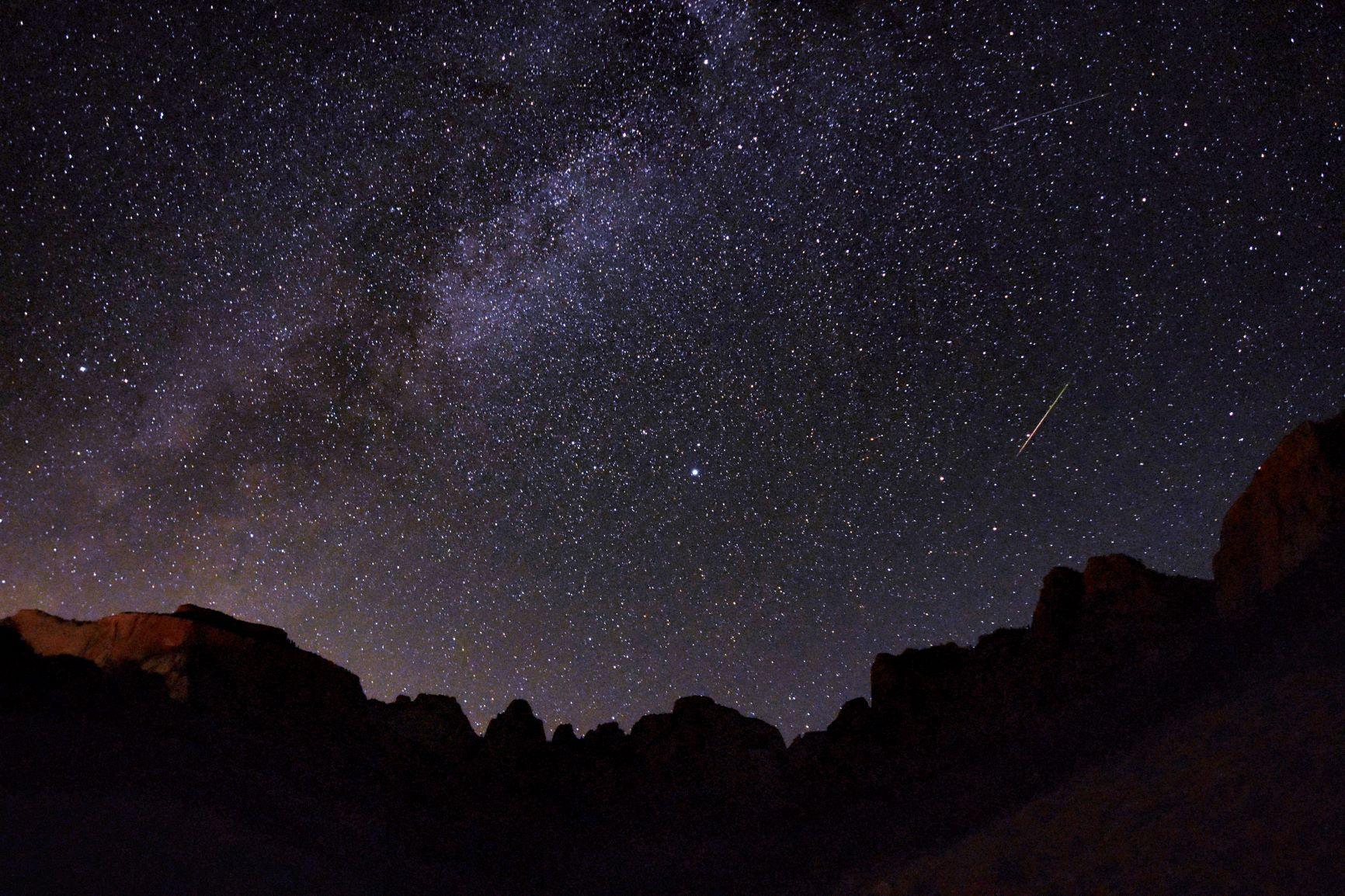 Starry night sky in Zion National Park with shooting star and milky way visible